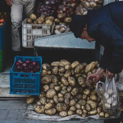 پیرمرد در حال خرید از میوه فروشی